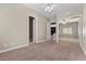 Neutral bedroom with a mirrored closet, carpet flooring, and views to other rooms at 2101 Strada Mia Ct, Las Vegas, NV 89117