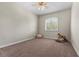 An empty bedroom featuring neutral carpet, base trim, a rocking horse and shutters at 2101 Strada Mia Ct, Las Vegas, NV 89117