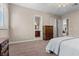 Bedroom featuring neutral carpet, base trim and access to a bathroom and additional rooms at 2101 Strada Mia Ct, Las Vegas, NV 89117