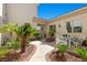 Charming courtyard featuring an intricate walkway, manicured tropical plants, and sitting area at 2101 Strada Mia Ct, Las Vegas, NV 89117