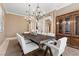 Elegant dining room featuring a modern chandelier, a large table, and white chairs at 2101 Strada Mia Ct, Las Vegas, NV 89117
