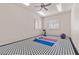 Bright fitness room with a black and white patterned floor and fitness accessories at 2101 Strada Mia Ct, Las Vegas, NV 89117
