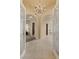 Elegant foyer with grand chandelier and decorative doors leading to various rooms at 2101 Strada Mia Ct, Las Vegas, NV 89117