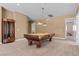 Spacious game room with a pool table, custom lighting, and neutral carpeting at 2101 Strada Mia Ct, Las Vegas, NV 89117