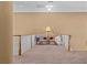 Neutral carpeted hallway area with sitting space by the railing at 2101 Strada Mia Ct, Las Vegas, NV 89117