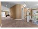 Spacious hallway with neutral carpet, detailed trim, and stairway to the right at 2101 Strada Mia Ct, Las Vegas, NV 89117
