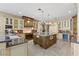 Gourmet kitchen with custom island, granite countertops, and stainless steel appliances at 2101 Strada Mia Ct, Las Vegas, NV 89117