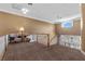Upstairs landing featuring 2 chairs, tan walls, and a view of the staircase at 2101 Strada Mia Ct, Las Vegas, NV 89117