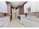 Well-equipped laundry room with storage cabinets, granite counters, modern appliances, and convenient sink at 2101 Strada Mia Ct, Las Vegas, NV 89117