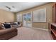 Well-lit living room with neutral walls, plantation shutters, and comfortable leather seating at 2101 Strada Mia Ct, Las Vegas, NV 89117