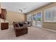 Inviting living room with doors to the outside, plush leather seating, and a built-in wet bar at 2101 Strada Mia Ct, Las Vegas, NV 89117