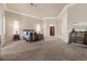 Spacious main bedroom featuring plush carpeting, a seating area, and an attached bathroom at 2101 Strada Mia Ct, Las Vegas, NV 89117