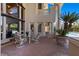 Outdoor patio with decorative brickwork, glass table, chairs, and view of pool at 2101 Strada Mia Ct, Las Vegas, NV 89117