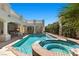 Beautiful pool and spa with a covered outdoor kitchen, bar, and a spiral staircase to the upper level at 2101 Strada Mia Ct, Las Vegas, NV 89117