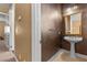 Powder room with pedestal sink, framed mirror, tiled floors and dramatic walls at 2101 Strada Mia Ct, Las Vegas, NV 89117