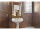Powder room with pedestal sink, framed mirror, tiled floors, shutters and dramatic walls at 2101 Strada Mia Ct, Las Vegas, NV 89117
