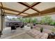 Inviting backyard featuring a covered patio, an above-ground pool, and lush landscaping at 2613 Country Mile Dr, Las Vegas, NV 89135