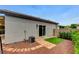 View of home backyard with artificial turf, pavers, and outdoor air conditioning unit at 2613 Country Mile Dr, Las Vegas, NV 89135