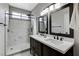 Nicely updated bathroom with dual sinks, granite countertops, and a large tiled walk-in shower at 2613 Country Mile Dr, Las Vegas, NV 89135