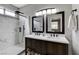 Well-lit bathroom featuring dual sinks, granite counters, and a full-size shower with gorgeous tile at 2613 Country Mile Dr, Las Vegas, NV 89135