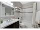 Bathroom features a dark vanity with white countertop, white tile, and bathtub with shower at 2613 Country Mile Dr, Las Vegas, NV 89135