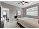 Bedroom with a ceiling fan, and a window with wooden blinds and a view to an outdoor patio at 2613 Country Mile Dr, Las Vegas, NV 89135