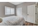Bedroom featuring a window with blinds, closet doors, and wood flooring at 2613 Country Mile Dr, Las Vegas, NV 89135