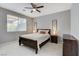 Bedroom with natural light, a ceiling fan, and a dark wood bed frame with matching furniture at 2613 Country Mile Dr, Las Vegas, NV 89135