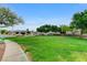 Neighborhood park featuring lush green grass, mature shade trees, and walking trails at 2613 Country Mile Dr, Las Vegas, NV 89135