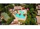 Aerial view of community pool with slides, playground, basketball court, and plenty of trees at 2613 Country Mile Dr, Las Vegas, NV 89135