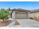 Charming single-story home featuring a two-car garage and a well-manicured front yard with desert landscaping at 2613 Country Mile Dr, Las Vegas, NV 89135