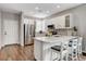 Beautiful kitchen with white cabinets, quartz countertops, stainless steel appliances, and seating for a modern, eat-in space at 2613 Country Mile Dr, Las Vegas, NV 89135