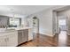 Bright kitchen featuring stainless steel appliances, white cabinets, and wood flooring, creating a modern and inviting space at 2613 Country Mile Dr, Las Vegas, NV 89135