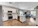 Modern kitchen with stainless steel appliances, white cabinets, and an open layout to the living area at 2613 Country Mile Dr, Las Vegas, NV 89135