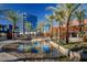 Modern water feature and landscaping near shops and office spaces with palm trees at 2613 Country Mile Dr, Las Vegas, NV 89135