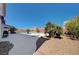 Expansive backyard featuring desert landscaping, a modern patio, and a pool at 2726 Manteno Ct, Henderson, NV 89052