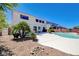 Backyard view of a white two-story house with a pool, patio, and desert landscaping at 2726 Manteno Ct, Henderson, NV 89052