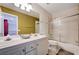 Bathroom featuring dual sinks, toilet, and bathtub with glass shower doors at 2726 Manteno Ct, Henderson, NV 89052
