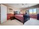 Bedroom with dark furniture, window, and ceiling fan at 2726 Manteno Ct, Henderson, NV 89052