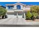 Charming two-story home with a three-car garage, well-manicured lawn, and inviting curb appeal at 2726 Manteno Ct, Henderson, NV 89052