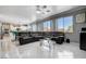 Bright living room with access to kitchen, featuring large windows and comfortable seating at 2726 Manteno Ct, Henderson, NV 89052
