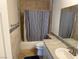 Clean bathroom featuring a shower/tub combo, neutral tile, and modern fixtures at 2796 Cape Hope Way, Las Vegas, NV 89121
