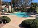 Community pool area with ample seating and lush landscaping; perfect for relaxation at 2796 Cape Hope Way, Las Vegas, NV 89121