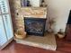 Stone fireplace with raised hearth and glass-fronted firebox provides an inviting focal point in the home at 2796 Cape Hope Way, Las Vegas, NV 89121