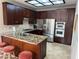 Modern kitchen with stainless steel appliances, granite counters, and dark wood cabinetry at 2796 Cape Hope Way, Las Vegas, NV 89121