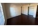 Bright bedroom featuring dark wood-look floors and a spacious closet at 2966 Juniper Hills Blvd # 102, Las Vegas, NV 89142