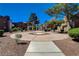 Common area with manicured landscaping, mature trees, and a decorative concrete pad, perfect for community gatherings at 2966 Juniper Hills Blvd # 102, Las Vegas, NV 89142