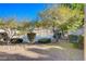 Enjoy the community pool surrounded by lush landscaping and mature trees on a clear blue sky day at 2966 Juniper Hills Blvd # 102, Las Vegas, NV 89142