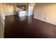 Open-concept living room with dark wood floors, ceiling fan, and bright neutral paint at 2966 Juniper Hills Blvd # 102, Las Vegas, NV 89142