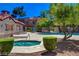 Community pool and hot tub area surrounded by lush greenery and landscaping, perfect for relaxation and enjoyment at 2966 Juniper Hills Blvd # 102, Las Vegas, NV 89142